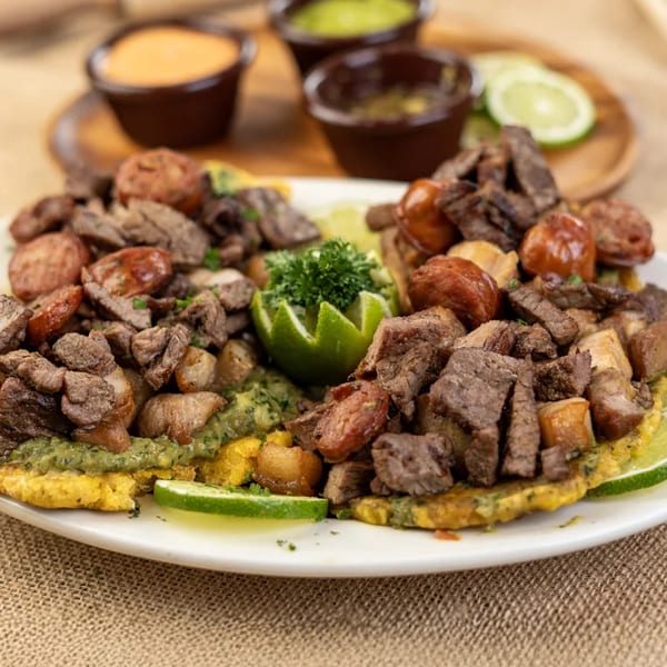 Colombian mixed grill picada with beef, sausage, and potatoes