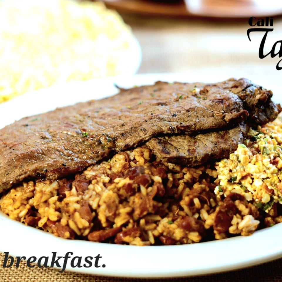 Tajadas breakfast with steak and rice